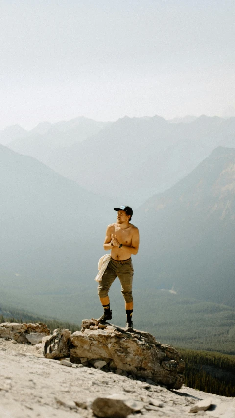 a man that is standing on a rock