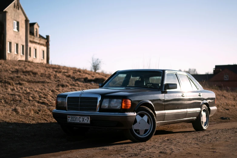 a black and white car is on the side of a hill