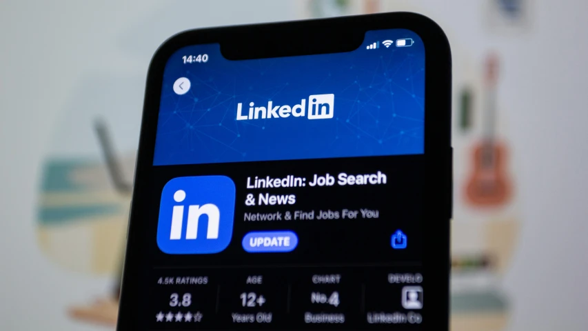 a phone is showing linkedium and the app logo