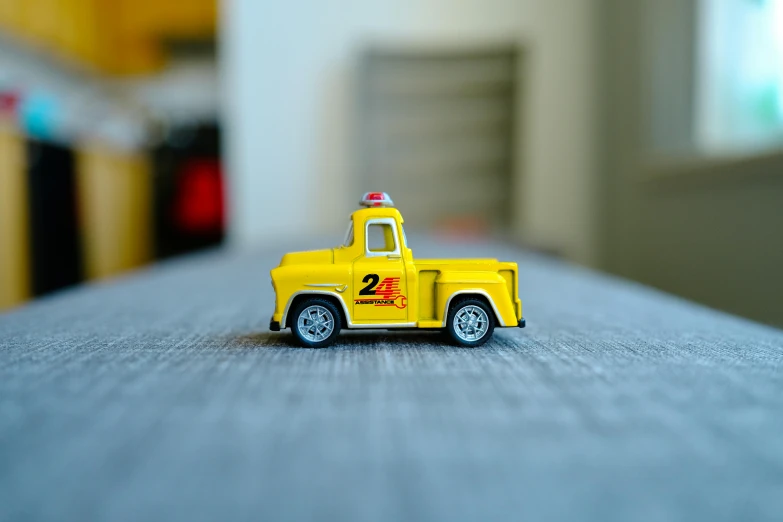 a small toy truck on a table in a room