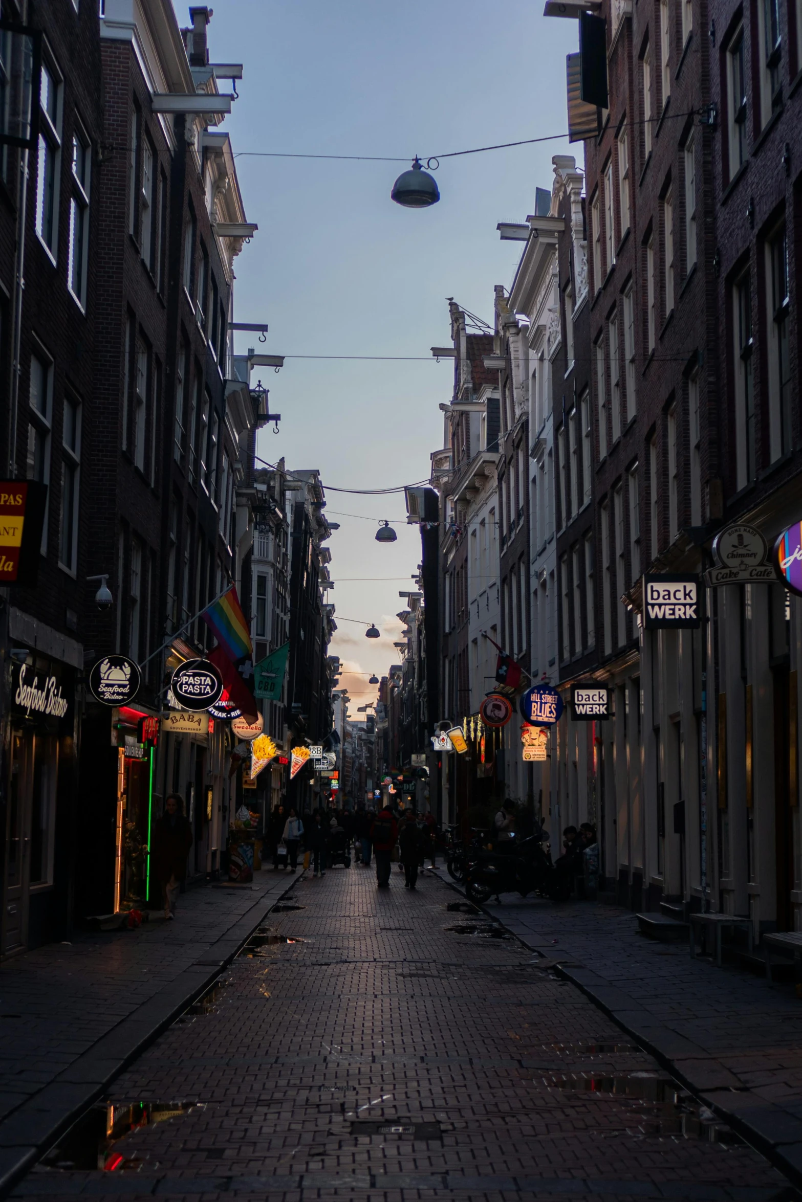 a very narrow city street with many different buildings