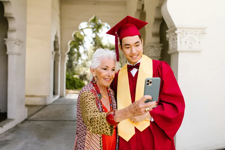 a couple pose for a pograph while they are graduating