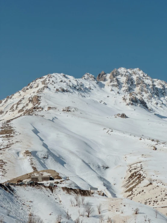 a mountain with snow on it in the middle of winter