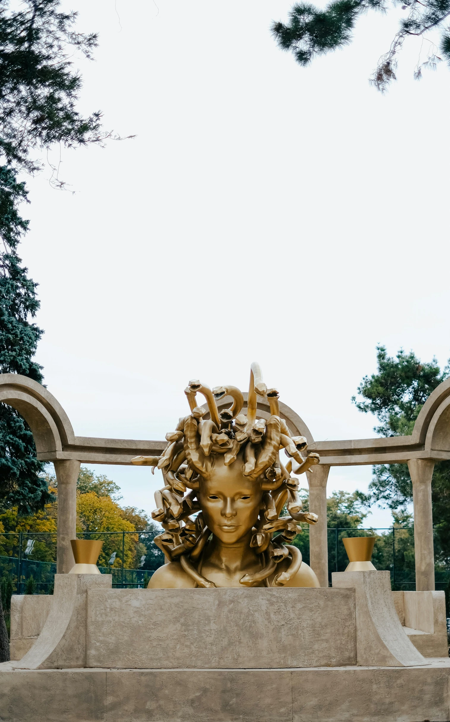 the statue has been sculpted with flowers and plants in its hair