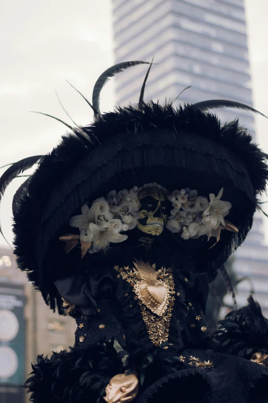 a fancy outfit with black feathers and a golden mask