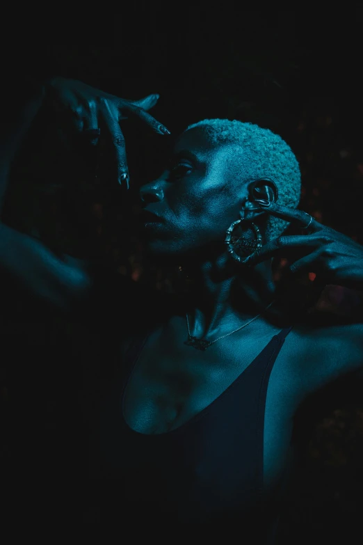 a woman wearing some kind of jewelry in the dark