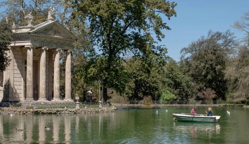 a man and a woman in a small boat on a lake