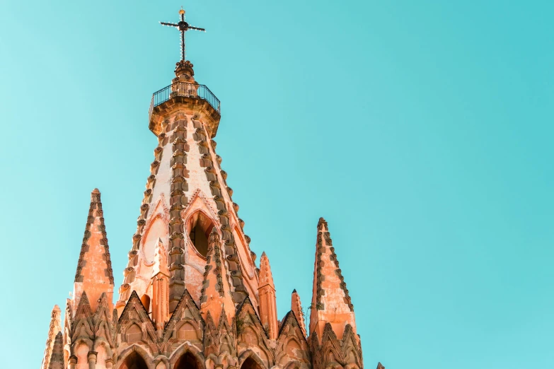 an ornate building has a large cross on top