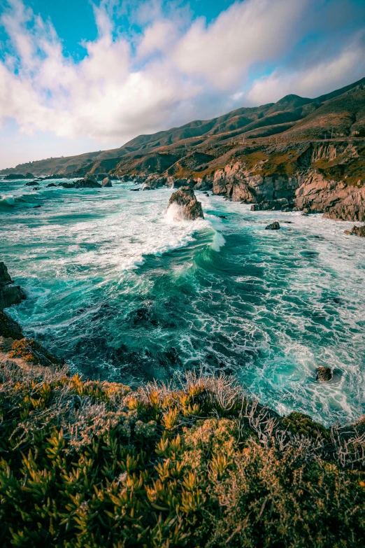 an ocean view with waves crashing on the shore