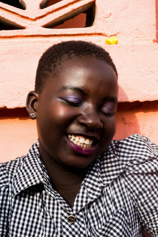 a black woman posing with her face painted blue