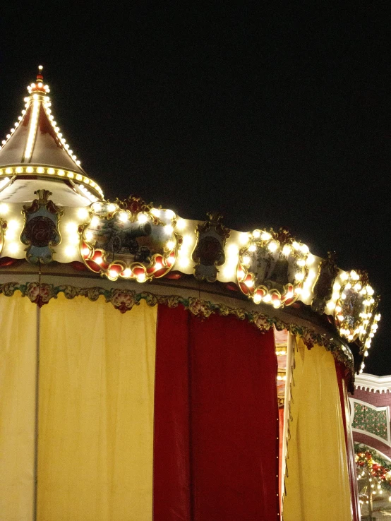 an merry go round sign is lit up at night