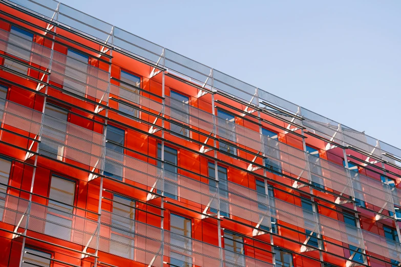 the side of a multi - story building made of windows and bars