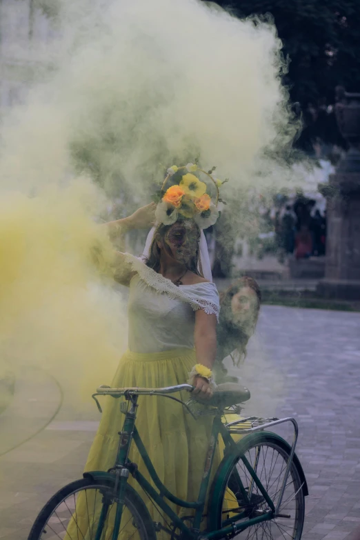 a woman on a bike wearing yellow and white