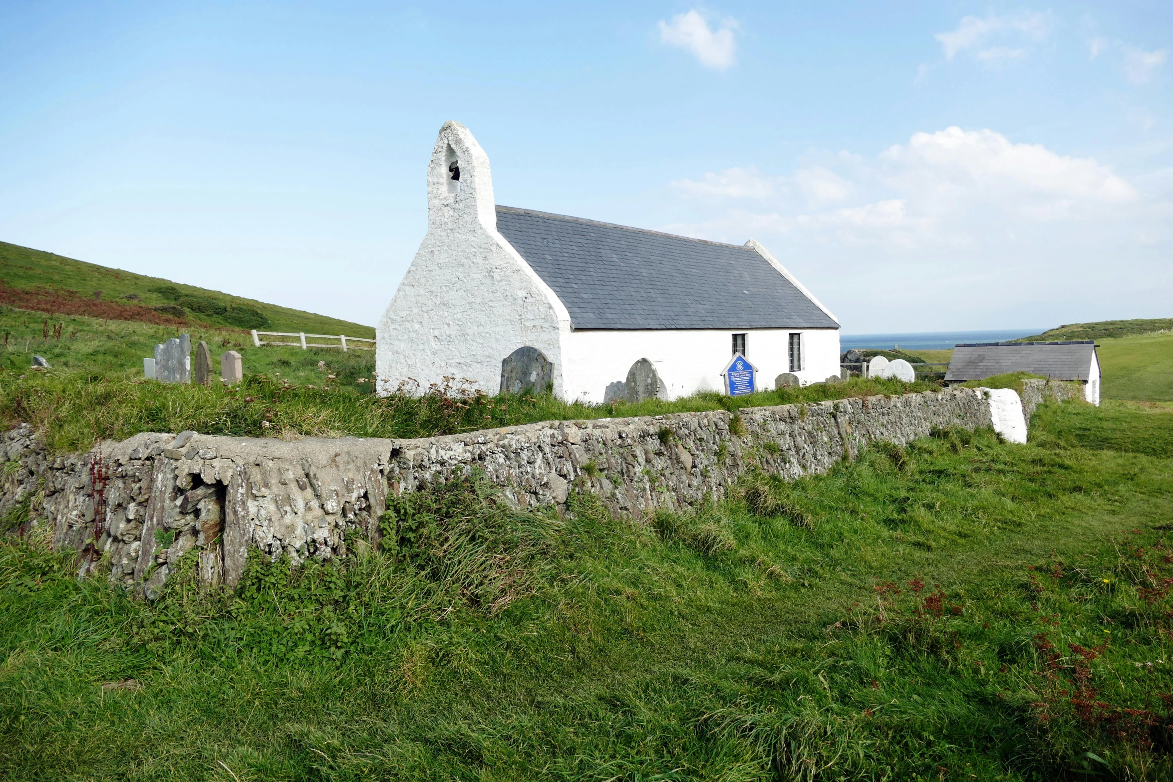 an old church in the countryside next to a cemetery