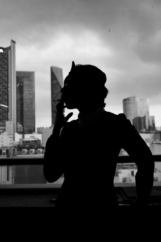 a person in silhouette talking on a cell phone