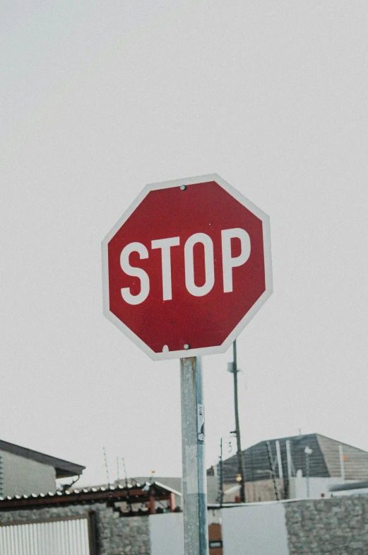 a stop sign that is on top of a pole