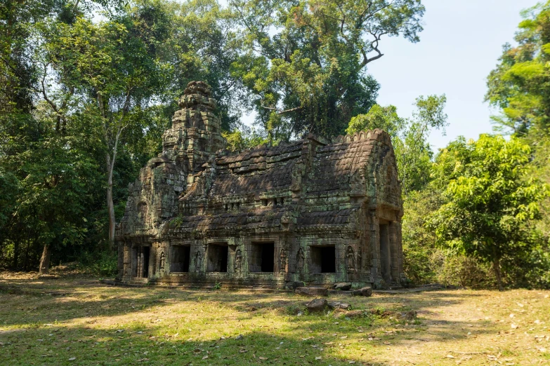 a building in a field that appears to be overgrown