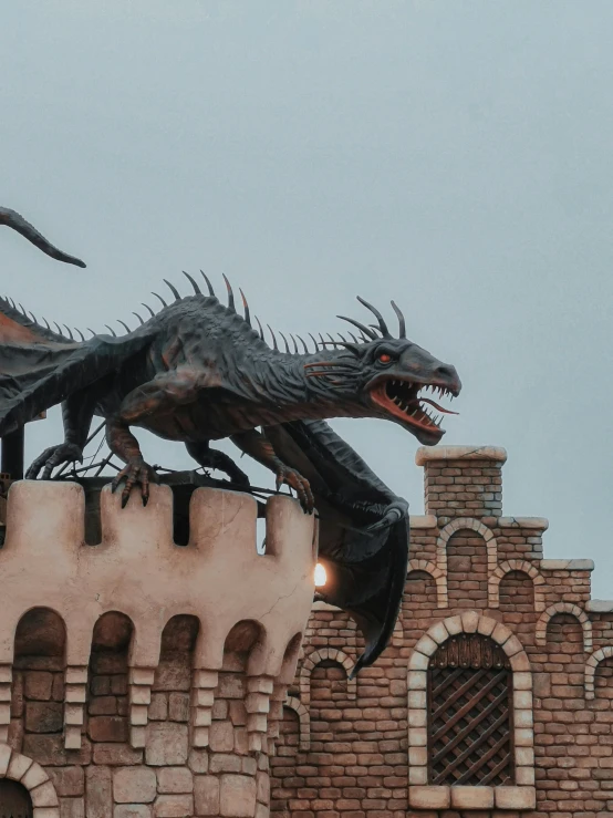 a statue of a dragon standing on top of a building