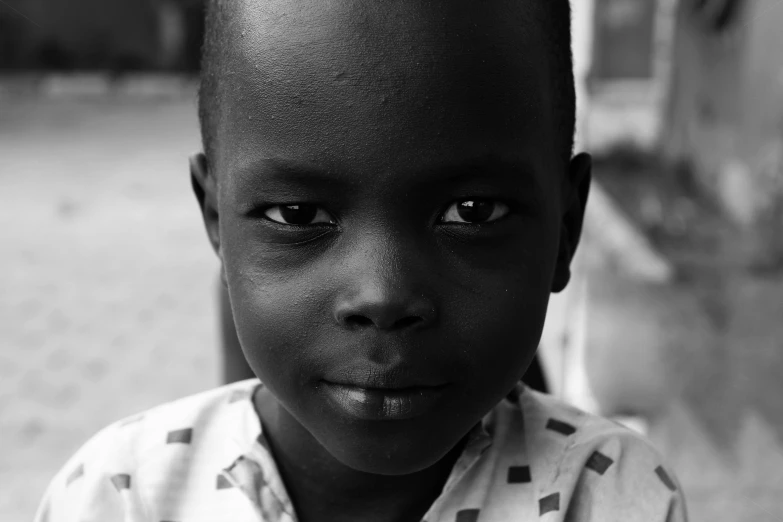 a boy is looking into the camera with his eyes wide open