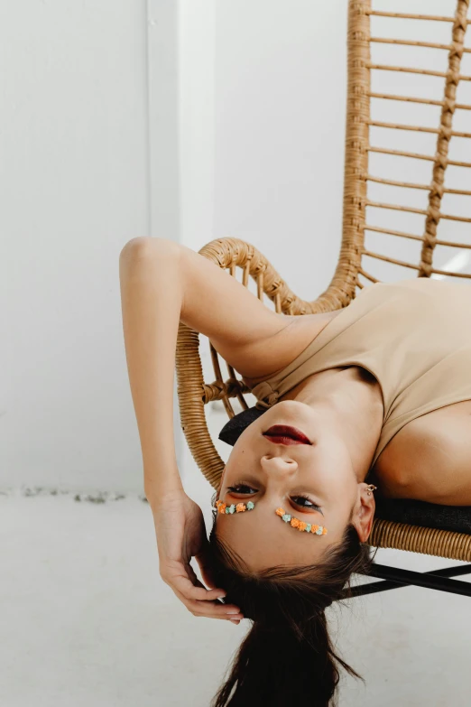 a woman with fake nails laying down on a chair