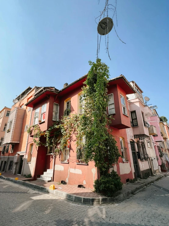 an apartment complex with many trees and vines growing on the building