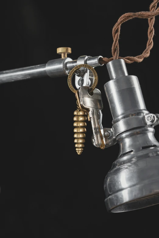 a hook is connected to an old style light bulb