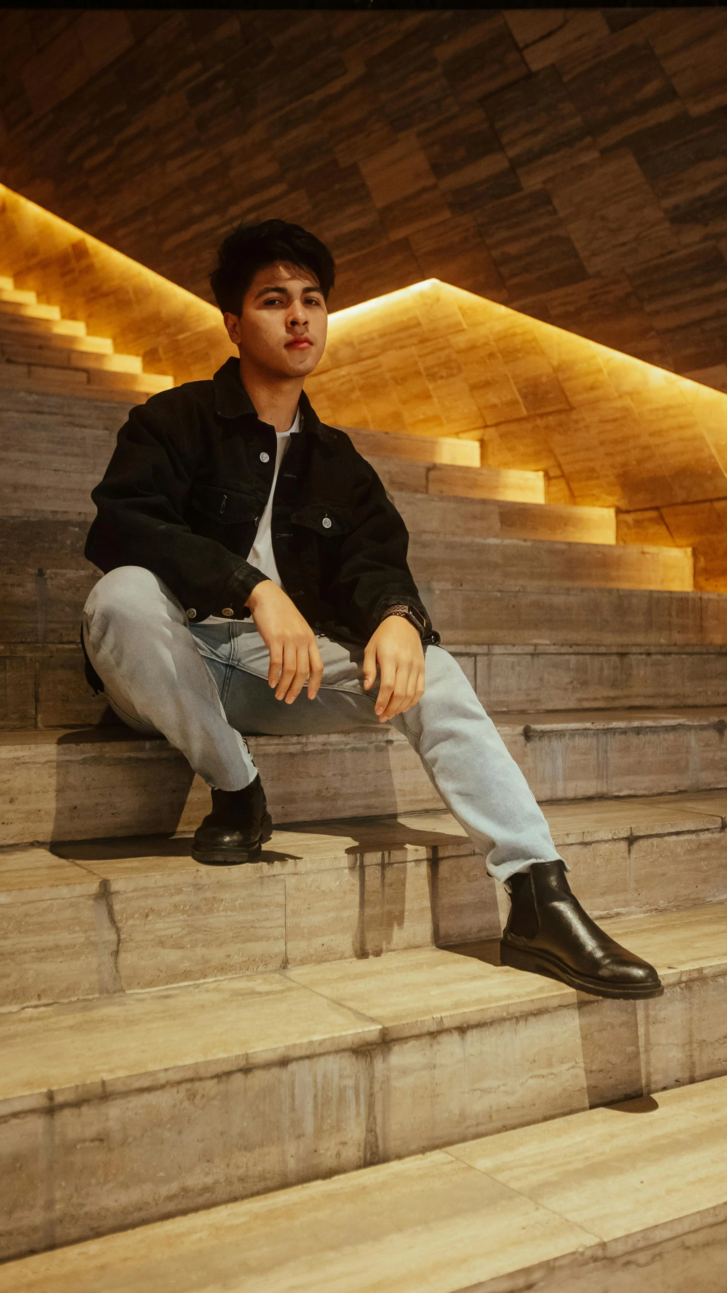 a man sitting on steps next to stairs