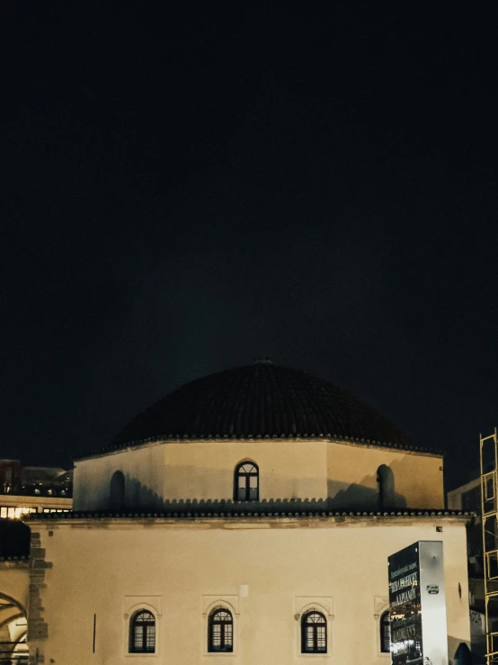 a building at night with people on it