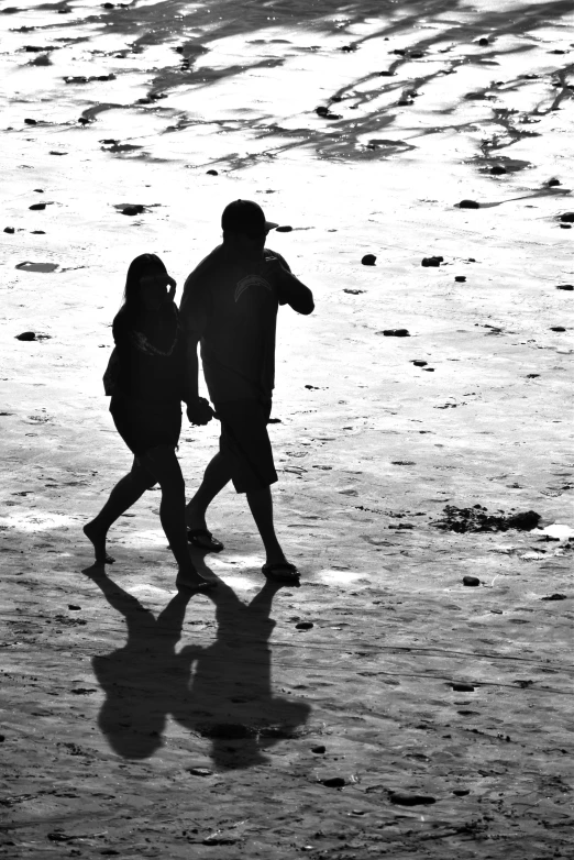 a black and white po of people on the beach