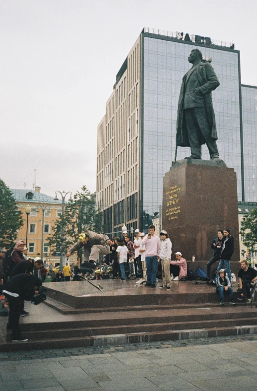 group of people taking pictures of statue in urban area