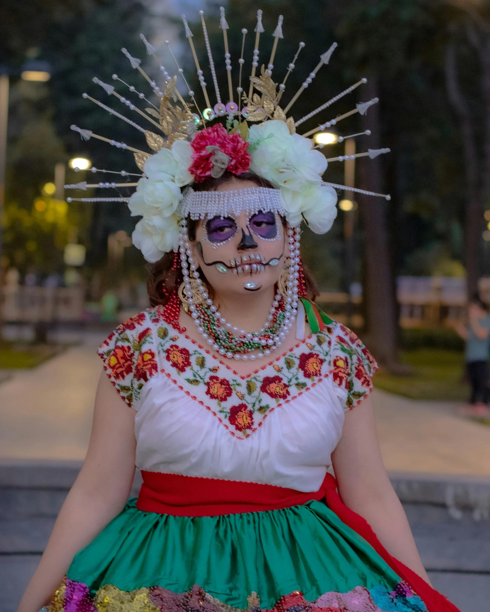 a woman is dressed in day of the dead clothing