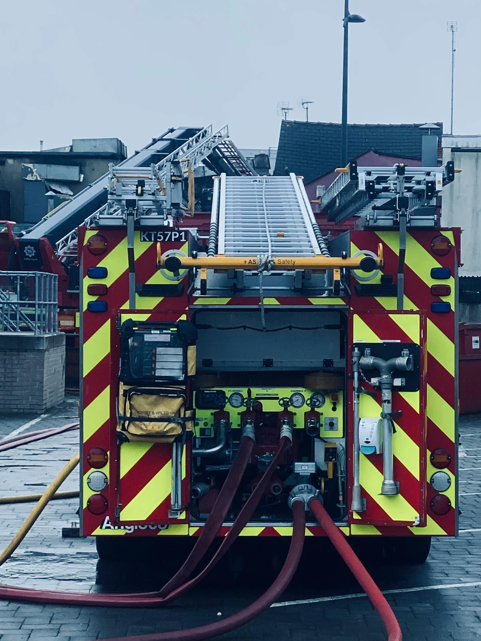 a fire truck with hoses connected to it's rear end