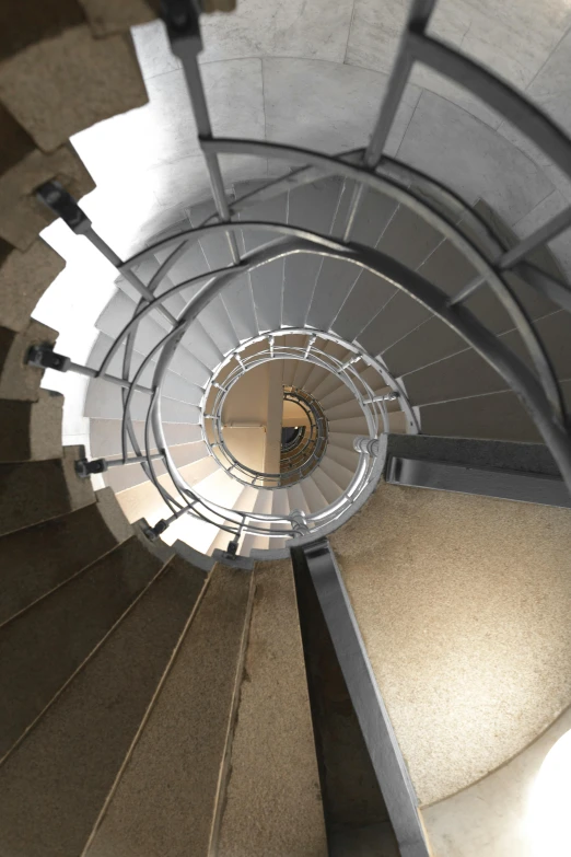 an indoor stair case made up of gray concrete