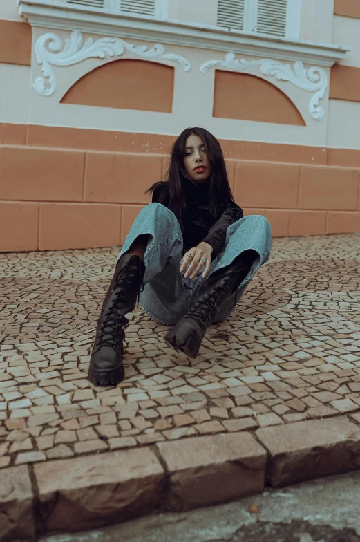 a woman sitting on the ground with a backpack