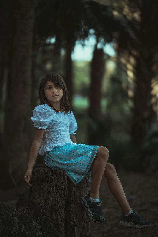  sitting on a log, posing for the camera