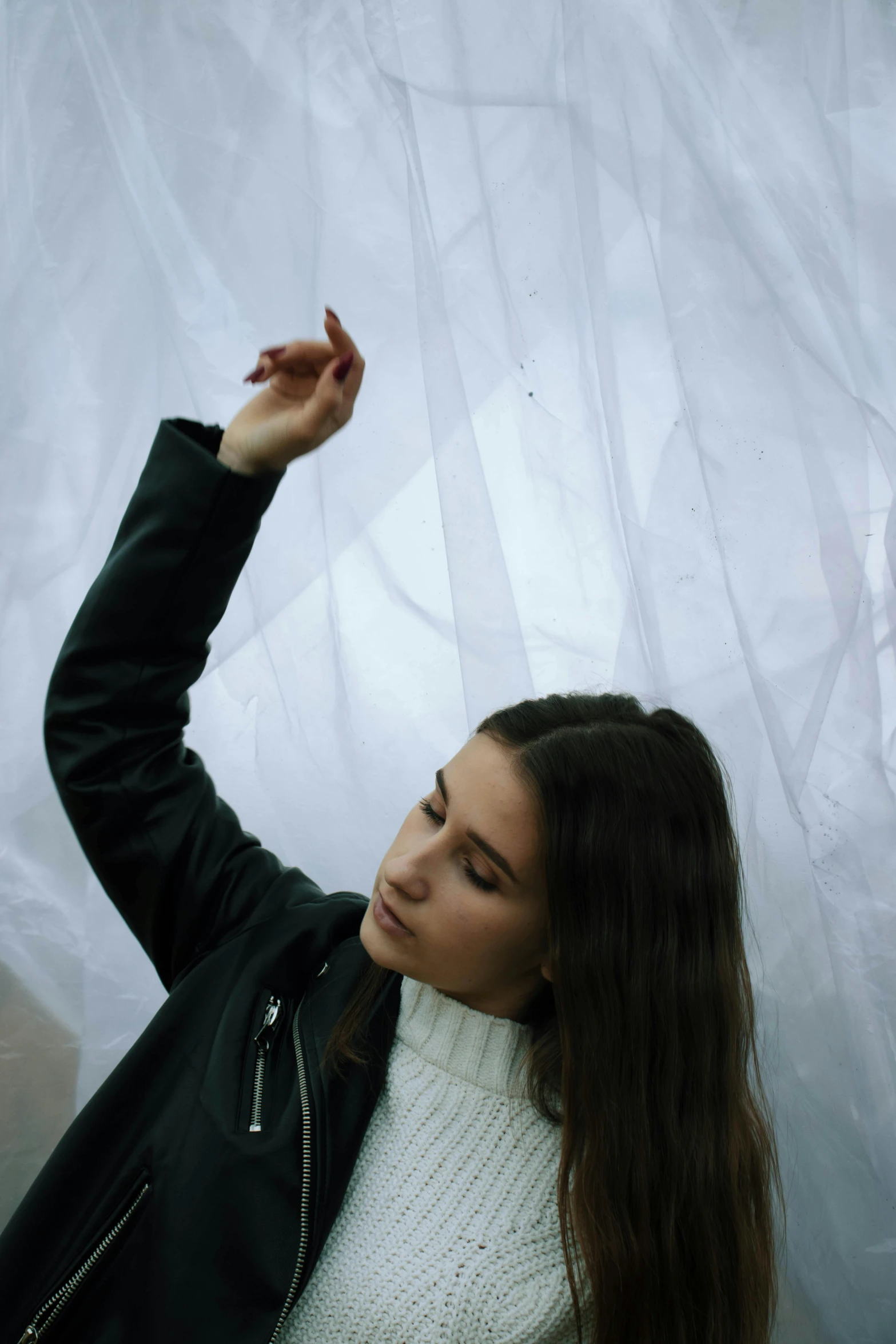 a woman in white shirt and black jacket posing for po