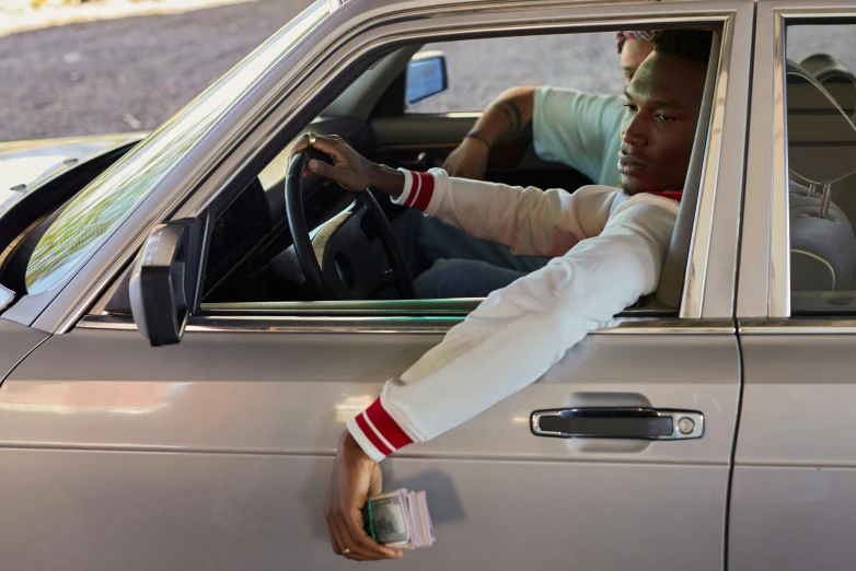 a man sitting in the drivers seat of a car