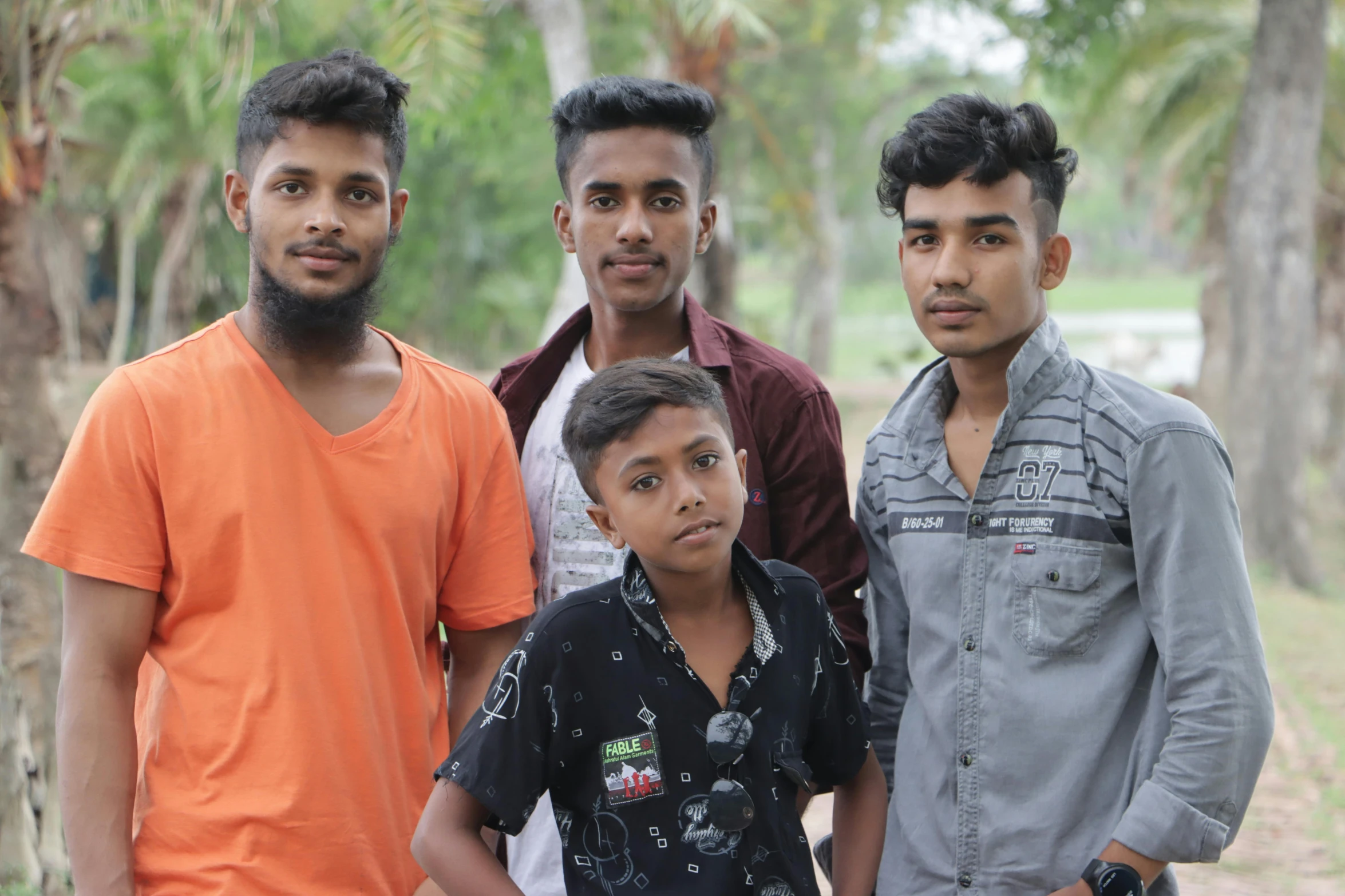 four men are standing in front of a jungle