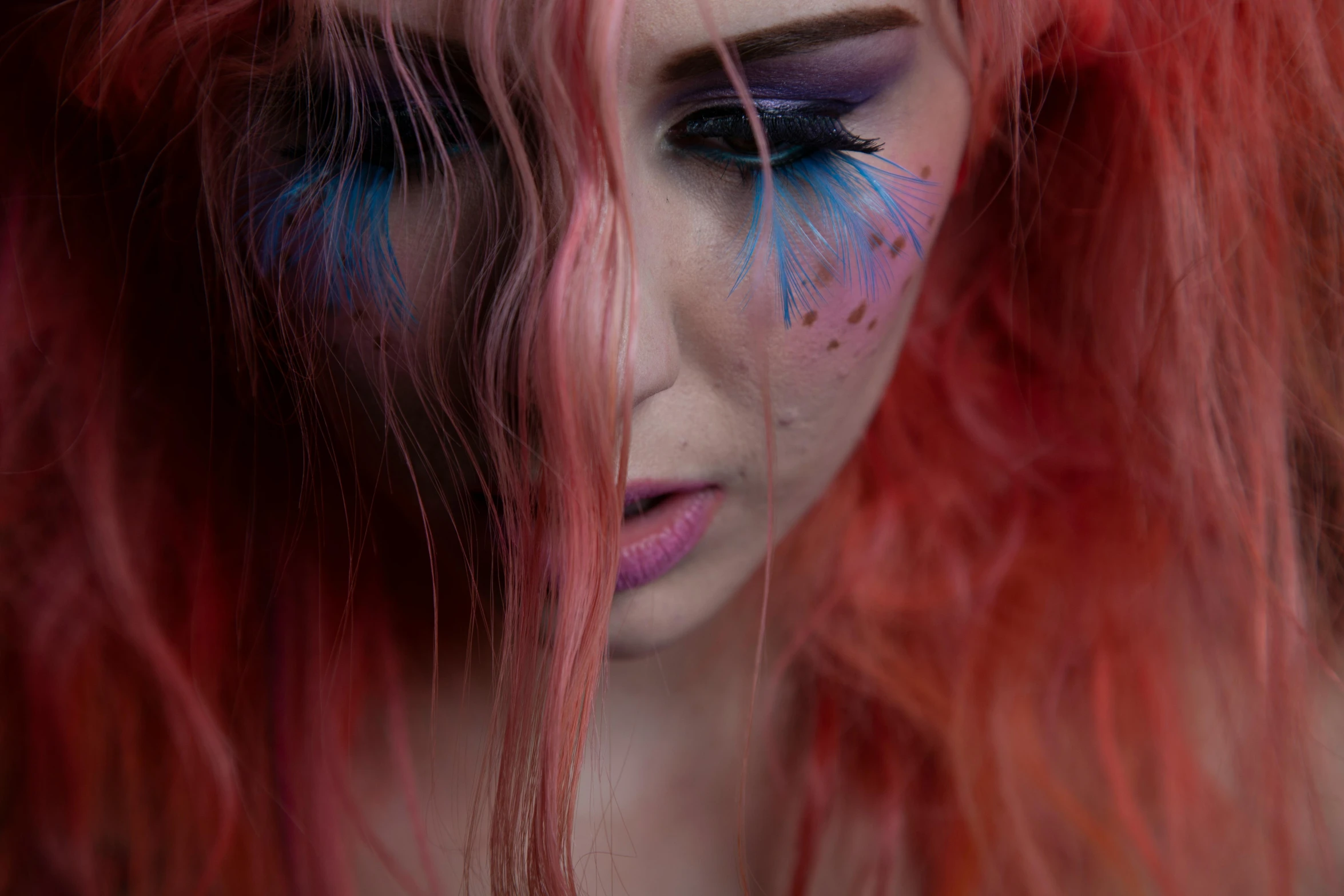 a girl with crazy hair and colorful makeup