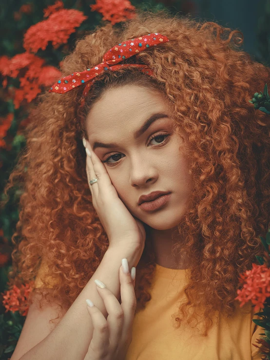 a young lady with long curly hair and bright makeup