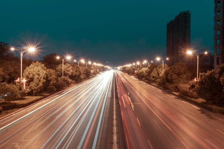 a city with lots of light traffic on it at night