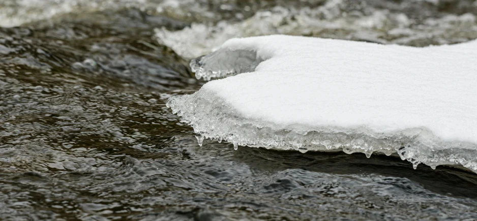 a large chunk of ice lying on top of a river