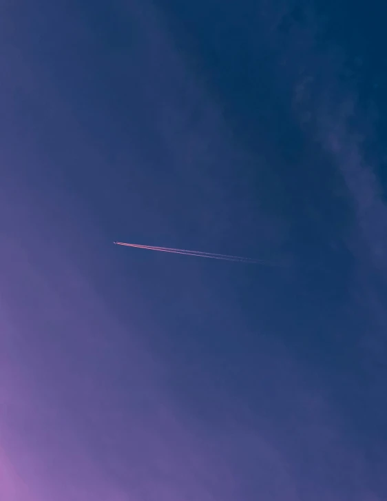 airplane flying high up in the sky and leaving the trail