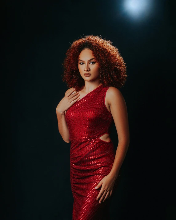 an elegant woman in a short red dress posing for the camera