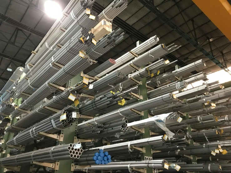 multiple metal tubes and machinery inside an assembly factory