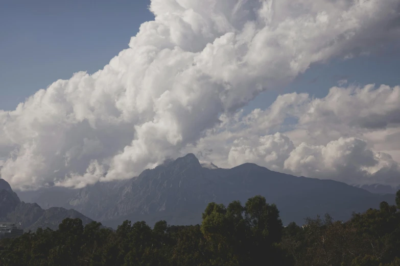 a mountain is shown behind some clouds in the distance