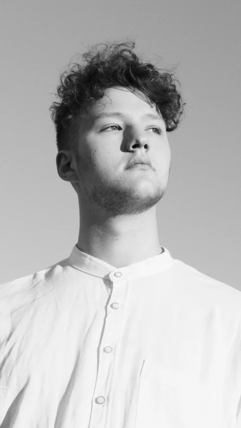 a black and white po of a man with a frizzy beard