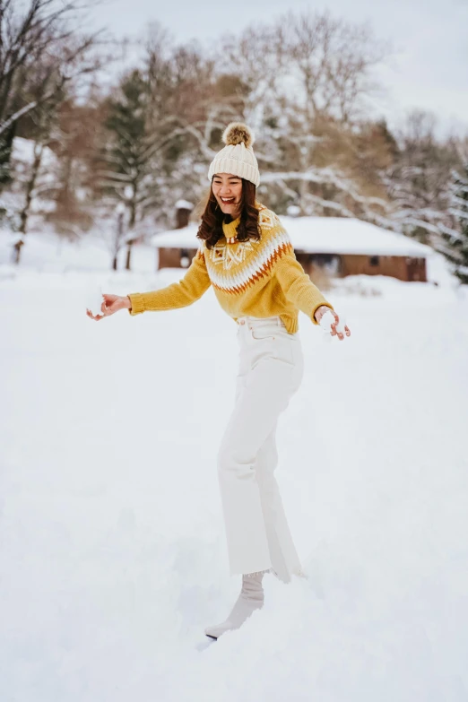 woman skating on snow in a park with trees in background