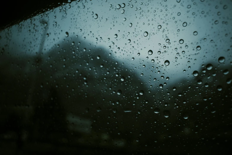 a window with water on it looking down the street