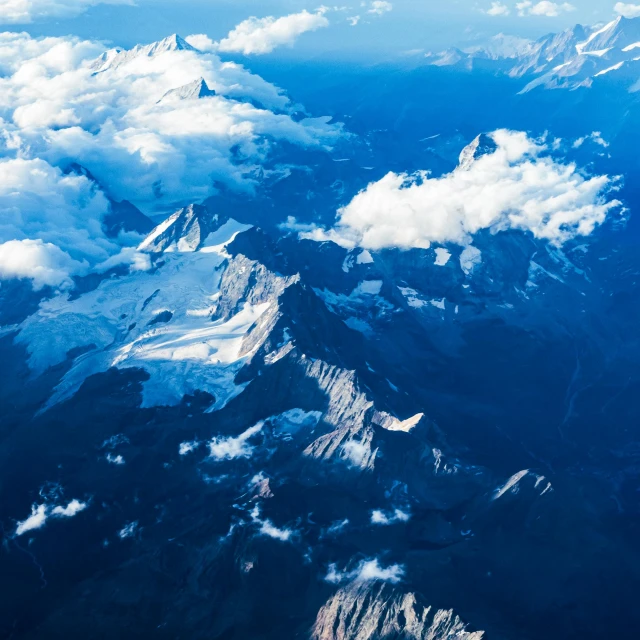 clouds are shown over a snowy mountain in this pograph